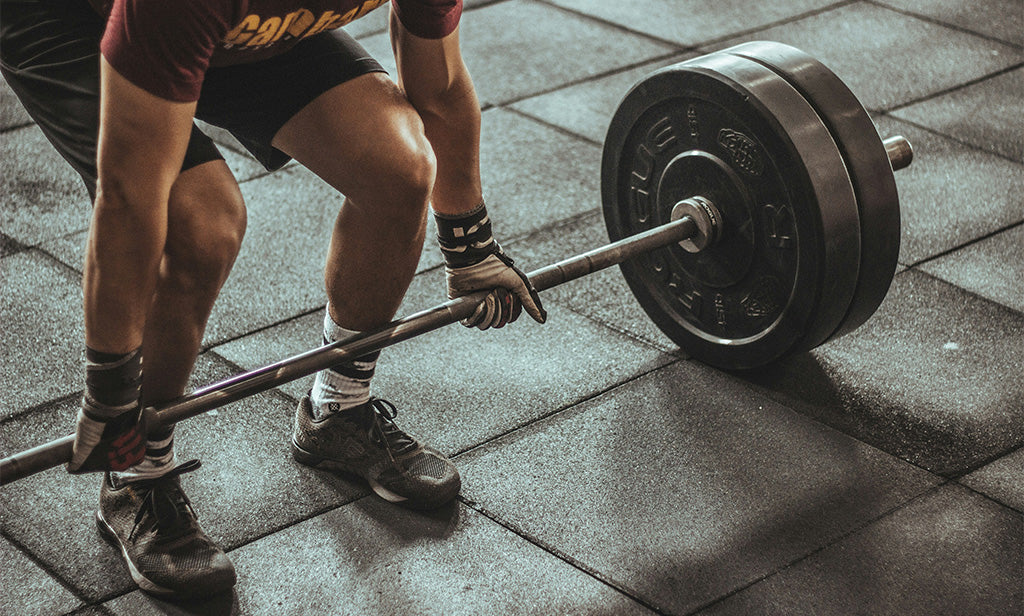 Man Lifting Weights In Gym