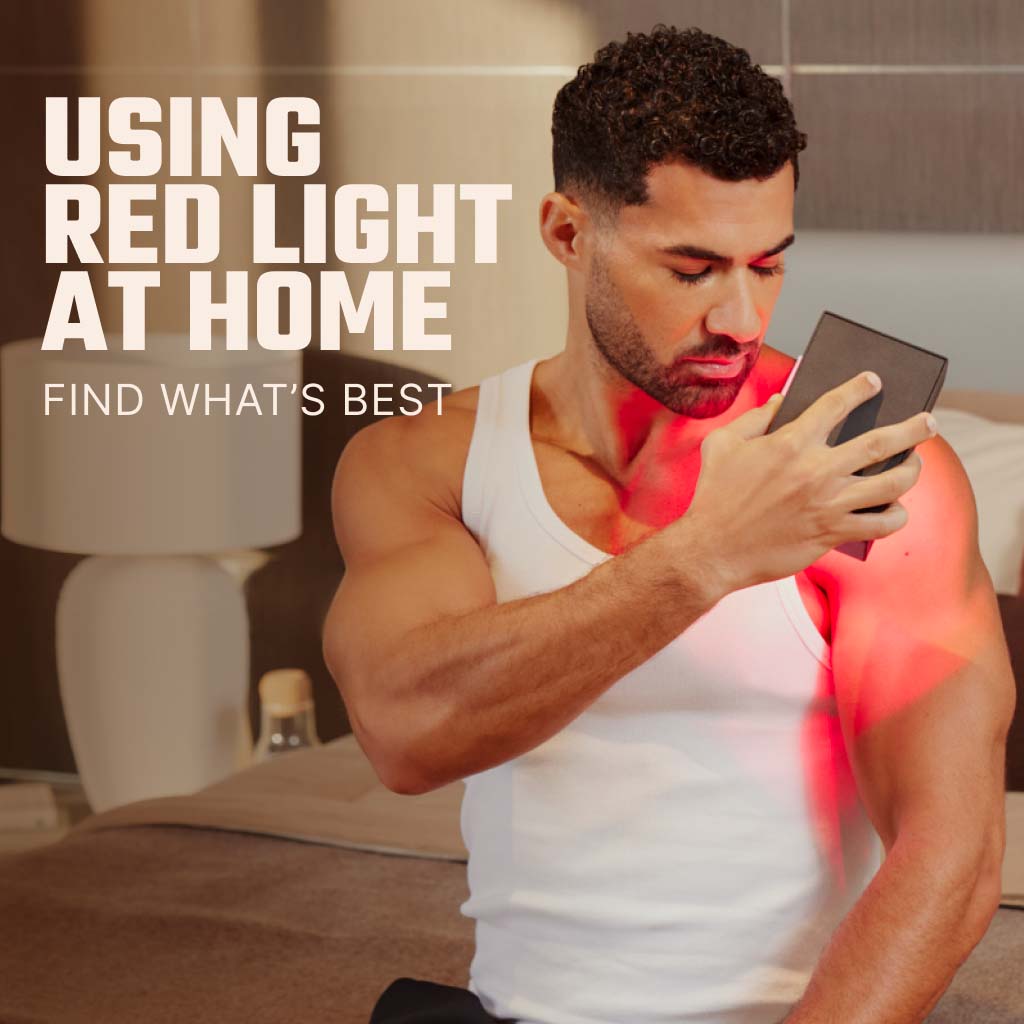 Man Holding Red Light Device Sitting On Bed