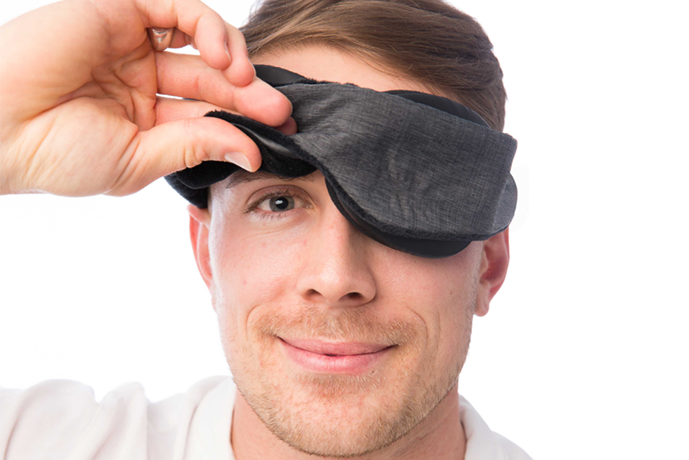 Man Removing Classic Blackout Sleep Mask