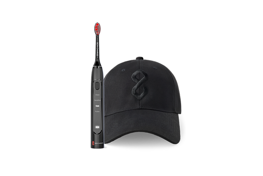 Black cap with logo and a black electric toothbrush